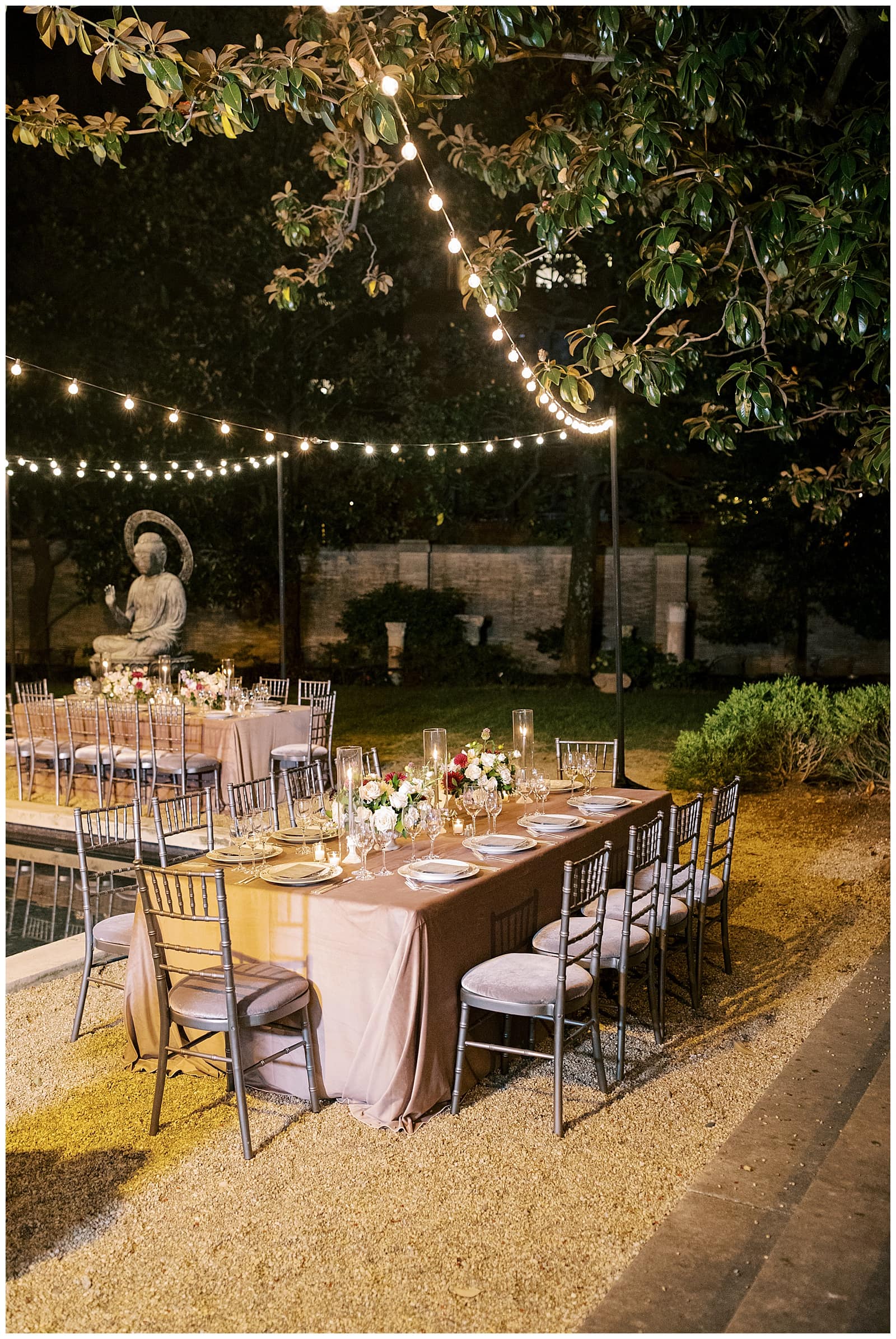 wedding reception table styled outside at night at the Anderson house with glowing string lights hanging above