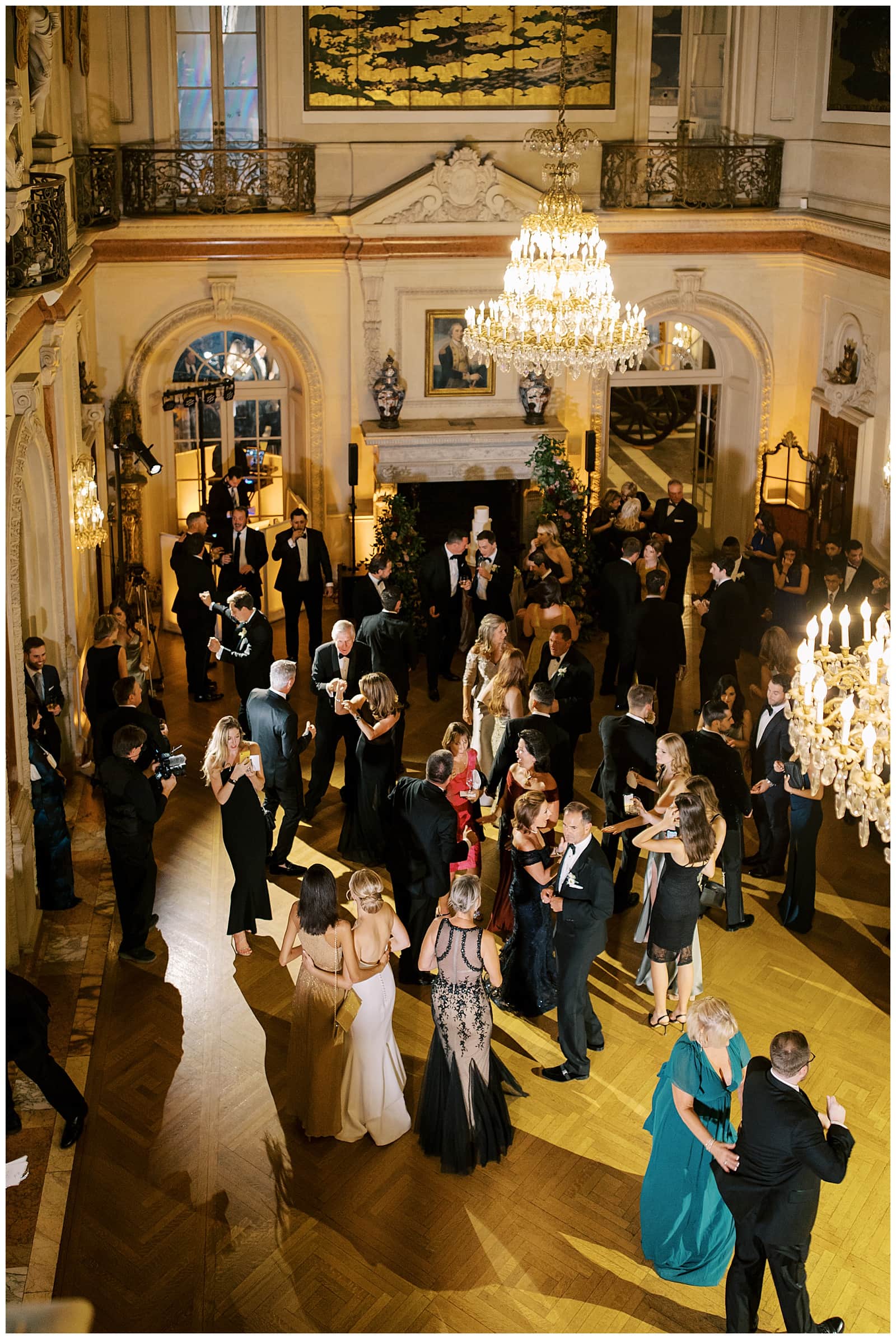 Aerial view of the ballroom at Larz Anderson House in Washington DC with black tie guests dancing inside