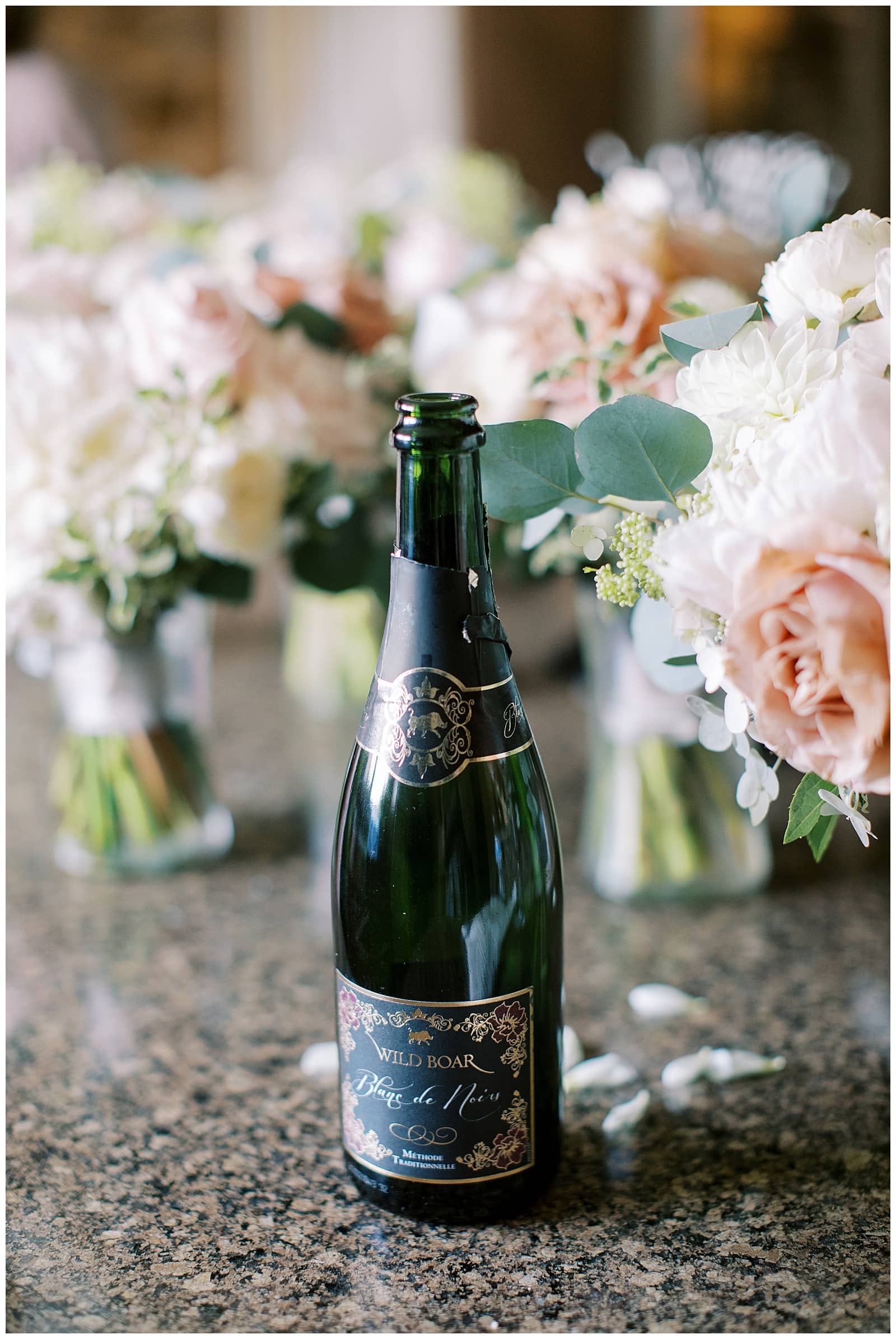 Bottle of Wine from Stone Tower Winery with bridal bouquets 