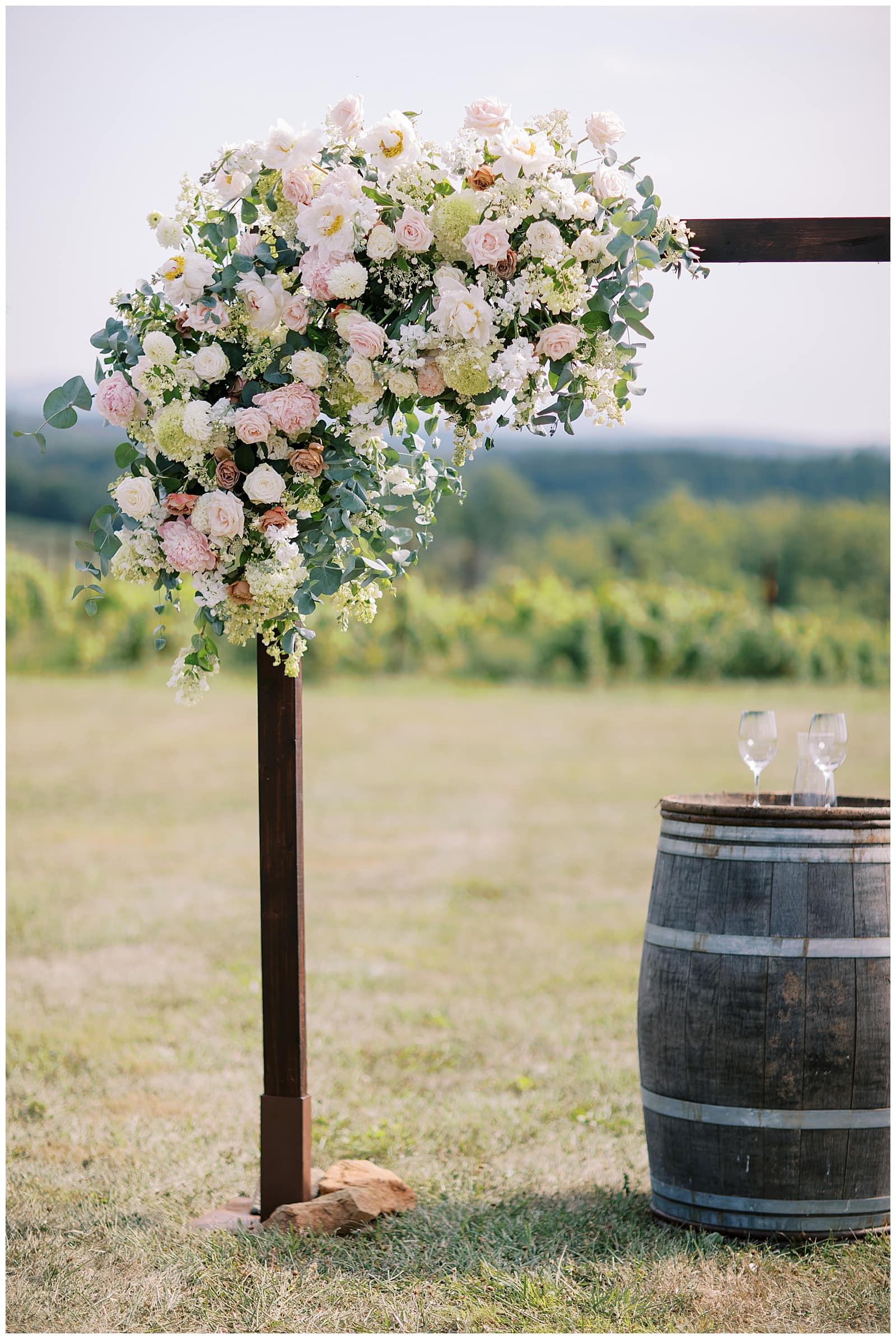 Massive floral arbor at the center of the ceremony site at Stone Tower Winery